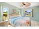 Coastal bedroom with wicker accents, calming colors, and a ceiling fan at 10444 Willmington Blvd, Englewood, FL 34224
