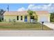 Lovely yellow home with attached garage, appealing landscaping, and a sunny curb appeal at 10444 Willmington Blvd, Englewood, FL 34224