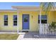 Inviting front entrance with a blue door, seahorse detail, and decorative touches at 10444 Willmington Blvd, Englewood, FL 34224