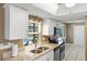 Bright kitchen features granite countertops, stainless steel appliances, and a view of the pool at 10444 Willmington Blvd, Englewood, FL 34224