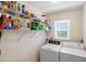 Convenient laundry room with shelving and modern washer and dryer at 10444 Willmington Blvd, Englewood, FL 34224