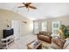 Cozy living room with tile flooring, ceiling fan, and comfortable seating arrangement at 10444 Willmington Blvd, Englewood, FL 34224