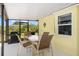 Covered back patio with grill, table and chairs at 10444 Willmington Blvd, Englewood, FL 34224