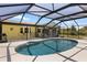 A screened-in pool with patio is surrounded by the yellow house at 10444 Willmington Blvd, Englewood, FL 34224