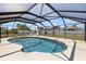 Private in-ground pool surrounded by a screened enclosure for outdoor enjoyment at 10444 Willmington Blvd, Englewood, FL 34224