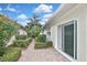 This back patio has brick pavers leading to the sliding glass doors at 1104 Auburn Cove Cir, Venice, FL 34292