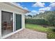 This back patio has brick pavers and sliding glass doors leading to the dining room at 1104 Auburn Cove Cir, Venice, FL 34292