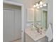 This bathroom features a single sink vanity, closet, and a mirrored cabinet at 1104 Auburn Cove Cir, Venice, FL 34292
