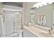 Bathroom featuring neutral tiling, walk in shower, and a large vanity at 1104 Auburn Cove Cir, Venice, FL 34292