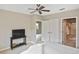 Relaxing bedroom with ceiling fan, and access to bathroom and walk in closet at 1104 Auburn Cove Cir, Venice, FL 34292