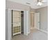Well-lit bedroom with organized closet space and a view into the hallway at 1104 Auburn Cove Cir, Venice, FL 34292