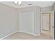 Neutral bedroom with double closet, ceiling fan, and doorway to the ensuite bathroom at 1104 Auburn Cove Cir, Venice, FL 34292