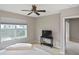 Cozy bedroom with natural light, a ceiling fan, and a TV on a sleek black stand at 1104 Auburn Cove Cir, Venice, FL 34292