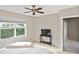 Bedroom with a ceiling fan, a large window and a TV on a black console at 1104 Auburn Cove Cir, Venice, FL 34292