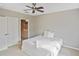 Comfortable bedroom with ceiling fan and view to an en-suite bathroom at 1104 Auburn Cove Cir, Venice, FL 34292