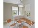 Charming breakfast nook with built-in seating, pendant lighting, and view to the front yard at 1104 Auburn Cove Cir, Venice, FL 34292