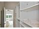 Walk-in closet with custom shelving and storage solutions, adjacent to the Primary bedroom at 1104 Auburn Cove Cir, Venice, FL 34292