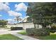 This single-story home showcases a two-car garage, a tidy yard, and a well-manicured hedge at 1104 Auburn Cove Cir, Venice, FL 34292