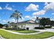 Beautiful home with a two-car garage, lush landscaping, and a well-manicured lawn at 1104 Auburn Cove Cir, Venice, FL 34292