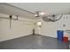 Organized garage with utility access, storage shelves, and epoxy flooring at 1104 Auburn Cove Cir, Venice, FL 34292