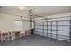 Spacious garage with workbench, overhead door, and natural light from window at 1104 Auburn Cove Cir, Venice, FL 34292