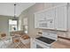 Bright kitchen features white appliances, granite countertops, and a cozy breakfast nook at 1104 Auburn Cove Cir, Venice, FL 34292