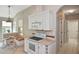 Bright kitchen features white appliances, granite countertops, and a cozy breakfast nook at 1104 Auburn Cove Cir, Venice, FL 34292
