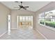 Bright, open living room featuring tile floors, a ceiling fan, and a view into the sun room at 1104 Auburn Cove Cir, Venice, FL 34292