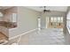 Spacious living area featuring tile floors, a kitchen bar, and sun room with lots of windows at 1104 Auburn Cove Cir, Venice, FL 34292