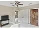 Bright bedroom with a ceiling fan and several doorways leading to other parts of the house at 1104 Auburn Cove Cir, Venice, FL 34292
