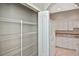 Spacious walk-in pantry with wire shelving for ample storage adjacent to kitchen at 1104 Auburn Cove Cir, Venice, FL 34292