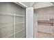 Pantry in the kitchen with shelving and access to the kitchen featuring white cabinets at 1104 Auburn Cove Cir, Venice, FL 34292