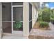 Screened in porch featuring decorative wreath with view to garden at 1104 Auburn Cove Cir, Venice, FL 34292