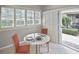 Cozy sun room with white shutters, a glass top table, and direct access to the outdoors at 1104 Auburn Cove Cir, Venice, FL 34292