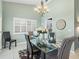 Comfortable dining space with glass table and upholstered chairs, bathed in natural light at 114 Southampton N Pl # 237, Venice, FL 34293