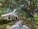 Charming single-story home with a well-maintained lawn, mature tree and welcoming entrance at 114 Southampton N Pl # 237, Venice, FL 34293