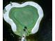 Scenic aerial view of a community golf course with pristine green, sand trap, and surrounding water at 114 Southampton N Pl # 237, Venice, FL 34293