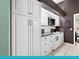 Classic kitchen with white cabinets, stainless steel microwave, and ample storage options at 114 Southampton N Pl # 237, Venice, FL 34293