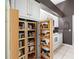 Organized pantry with pull out shelving offering plenty of storage for kitchen essentials at 114 Southampton N Pl # 237, Venice, FL 34293