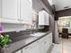 Well-maintained kitchen featuring white cabinetry, granite countertops, and stainless steel appliances at 114 Southampton N Pl # 237, Venice, FL 34293