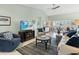 Bright and airy living room showcasing vaulted ceilings, tile flooring, and stylish decor at 114 Southampton N Pl # 237, Venice, FL 34293