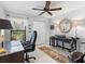 Functional home office with a ceiling fan, desk, chair, and a window offering outdoor views at 114 Southampton N Pl # 237, Venice, FL 34293