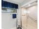 Updated shower featuring glass doors, grab bars, and tiled walls, creating a modern and accessible space at 114 Southampton N Pl # 237, Venice, FL 34293