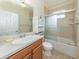 Bright bathroom with large mirror, single vanity, and shower-tub combination at 11649 Tempest Harbor Loop, Venice, FL 34292