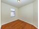 Bright bedroom with hardwood floors and a window allowing natural light at 11649 Tempest Harbor Loop, Venice, FL 34292