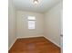 Bedroom featuring wood floors, a window, and neutral paint at 11649 Tempest Harbor Loop, Venice, FL 34292