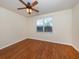 Cozy bedroom featuring beautiful wood floors and a window for natural light at 11649 Tempest Harbor Loop, Venice, FL 34292