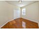 Bedroom featuring wood floors, double closet, and a window for natural light at 11649 Tempest Harbor Loop, Venice, FL 34292