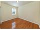 Bedroom featuring wood floors and a window for natural light at 11649 Tempest Harbor Loop, Venice, FL 34292