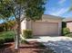 Home exterior with a two-car garage, driveway, and landscaped front yard at 11649 Tempest Harbor Loop, Venice, FL 34292